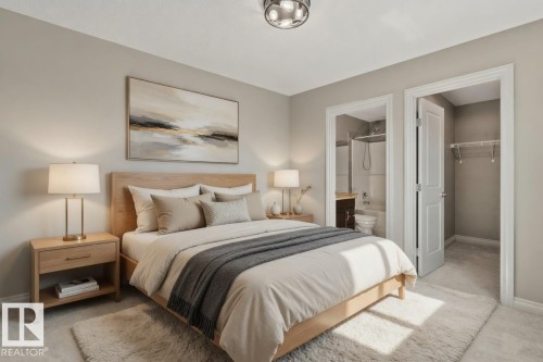 Bedroom featuring carpet flooring, a ceiling-mounted light fixture, and two doorways - 46 445 Brintnell Boulevard, Edmonton, AB - Indoor Photo Showing Bedroom