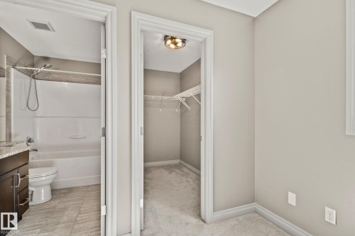 Walk-in closet with carpet flooring and overhead lighting - 46 445 Brintnell Boulevard, Edmonton, AB - Indoor Photo Showing Bathroom