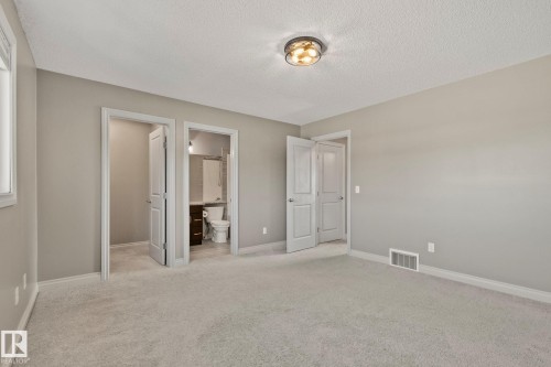 Carpeted room with neutral wall tones and a ceiling-mounted light fixture - 46 445 Brintnell Boulevard, Edmonton, AB - Indoor Photo Showing Other Room