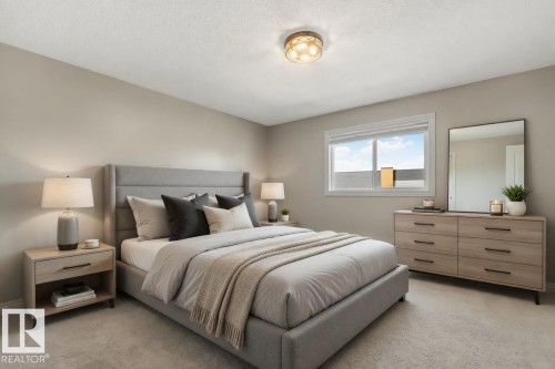 Carpeted bedroom featuring neutral-toned walls, a single window with white trim, and a ceiling-mounted light fixture - 46 445 Brintnell Boulevard, Edmonton, AB - Indoor Photo Showing Bedroom