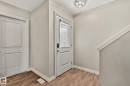Entryway featuring wood-finish flooring, white trim, and light gray walls - 46 445 Brintnell Boulevard, Edmonton, AB  - Indoor Photo Showing Other Room 