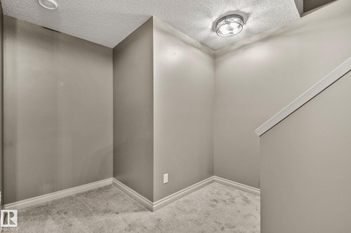 Carpeted landing with neutral wall paint and white trim - 46 445 Brintnell Boulevard, Edmonton, AB - Indoor Photo Showing Other Room
