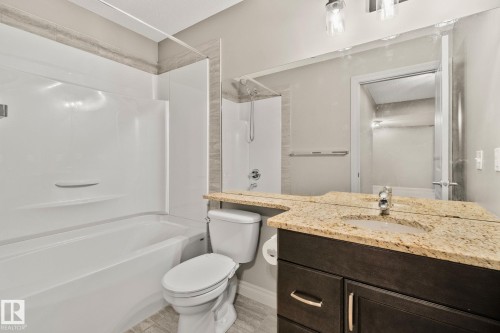 Bathroom featuring a combined tub and shower unit with a tile surround - 46 445 Brintnell Boulevard, Edmonton, AB - Indoor Photo Showing Bathroom