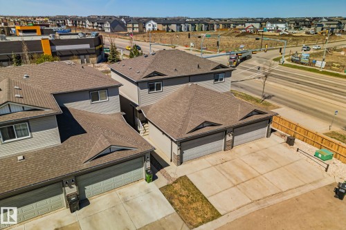 Contemporary residential structure featuring gray siding and a brown shingle roof - 46 445 Brintnell Boulevard, Edmonton, AB - Outdoor