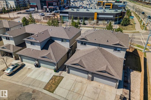 Townhome-style residences featuring grey siding and brown shingle roofs - 46 445 Brintnell Boulevard, Edmonton, AB - Outdoor