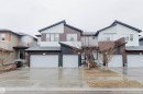 Modern townhome exterior featuring an attached garage, multi-toned siding, and a gabled roofline - 1793 Keene Crescent, Edmonton, AB  - Outdoor With Facade 