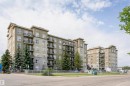 Multi-story residential buildings featuring varied facade treatments including stone accents, stucco, and prominent balconies with metal railings - 1-402 4245 139 Avenue, Edmonton, AB  - Outdoor With Balcony With Facade 