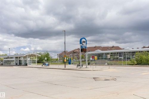 Transit station featuring modern architecture with a curved roofline and extensive glass panels - 1-402 4245 139 Avenue, Edmonton, AB - Outdoor