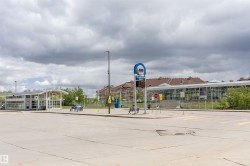 Transit station featuring modern architecture with a curved roofline and extensive glass panels - 