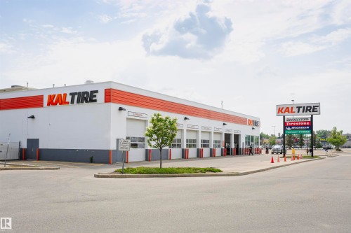 Commercial building with a white and orange exterior and multiple service bays - 1-402 4245 139 Avenue, Edmonton, AB - Outdoor