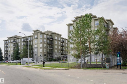 Modern multi-story residential building featuring a neutral-toned facade with stone accents - 1-402 4245 139 Avenue, Edmonton, AB - Outdoor With Balcony With Facade