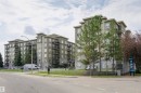 Modern multi-story residential building featuring a neutral-toned facade with stone accents - 1-402 4245 139 Avenue, Edmonton, AB  - Outdoor With Balcony With Facade 