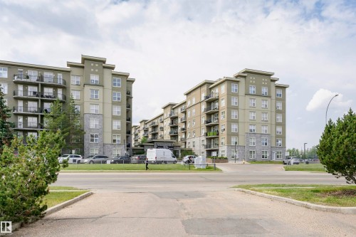 Multi-story residential complex featuring contemporary architecture with stone and stucco facade - 1-402 4245 139 Avenue, Edmonton, AB - Outdoor With Balcony With Facade