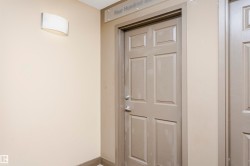 Entryway featuring a six-panel door with a brushed nickel doorknob and deadbolt - 