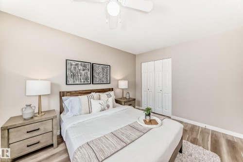 This room features light-toned walls, hardwood style flooring, and a ceiling fan - 10327 150 Street, Edmonton, AB - Indoor Photo Showing Bedroom