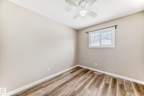 This room features wood-style flooring, a window providing natural light, and a ceiling fan - 10327 150 Street, Edmonton, AB - Indoor Photo Showing Other Room