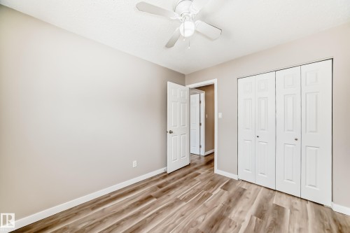 This room features neutral-toned walls, wood-look flooring, and a ceiling fan - 10327 150 Street, Edmonton, AB - Indoor Photo Showing Other Room