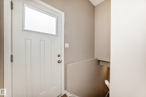 Entryway featuring a white door with a window and paneling details - 10327 150 Street, Edmonton, AB - Indoor Photo Showing Other Room