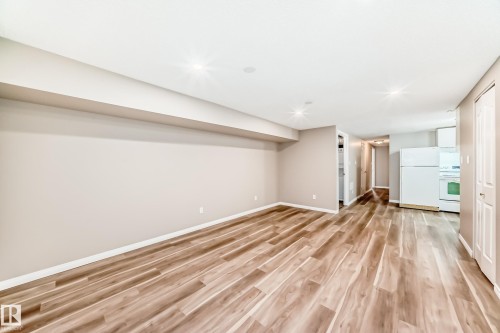 The property features wood-style flooring, light-colored walls, and recessed lighting - 10327 150 Street, Edmonton, AB - Indoor Photo Showing Other Room
