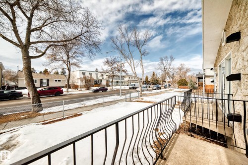 The property features a balcony with black metal railings, offering a view of the street - 10327 150 Street, Edmonton, AB - Outdoor