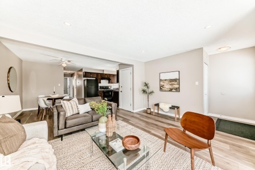 Open concept living area with light-toned walls, recessed lighting, and wood-style flooring - 10327 150 Street, Edmonton, AB - Indoor Photo Showing Living Room