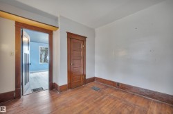 Warm wood-finish flooring complemented by substantial wood trim and baseboards - 