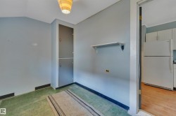 Interior space featuring a built-in double cabinet, a wall-mounted shelf, and an overhead light fixture - 