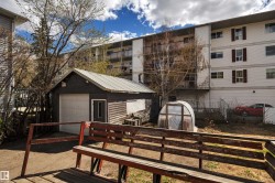 Detached garage with a metal roof and a side access door - 
