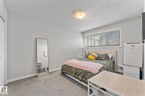 Bedroom featuring light gray walls, textured ceiling, and gray carpeting - 35 Mcleod Place, Edmonton, AB - Indoor Photo Showing Bedroom