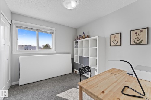 Carpeted room with a double-paned window, neutral wall paint, white trim, and a white ceiling light fixture - 35 Mcleod Place, Edmonton, AB - Indoor