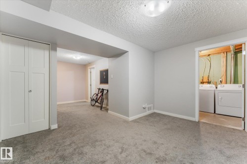 Carpeted interior space with light gray wall paint and a textured ceiling - 35 Mcleod Place, Edmonton, AB - Indoor Photo Showing Other Room