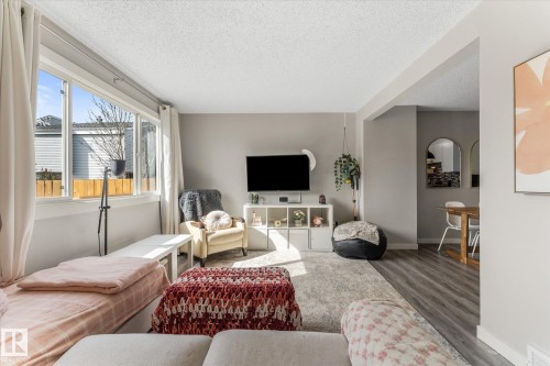Living area featuring light grey walls, white trim, and a large picture window - 35 Mcleod Place, Edmonton, AB - Indoor Photo Showing Other Room