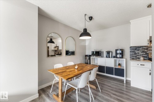 Dining area featuring wood-finish flooring and a black pendant light fixture - 35 Mcleod Place, Edmonton, AB - Indoor Photo Showing Dining Room