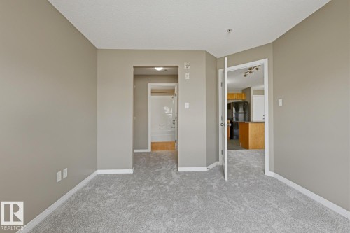 Interior space featuring light gray carpet flooring and neutral wall tones - 5106 7335 South Terwillegar Drive, Edmonton, AB - Indoor Photo Showing Other Room