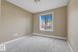 Bedroom featuring light gray carpet flooring and neutral wall tones - 