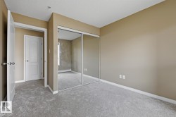 Room featuring light tan walls, light gray carpet flooring, and white baseboards - 