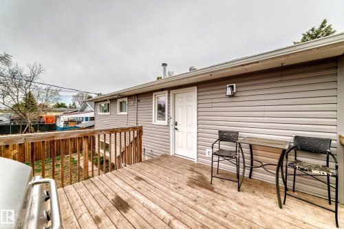 Spacious wood-finish deck with wooden railings, providing outdoor living space - 3802 52 Street, Wetaskiwin, AB 