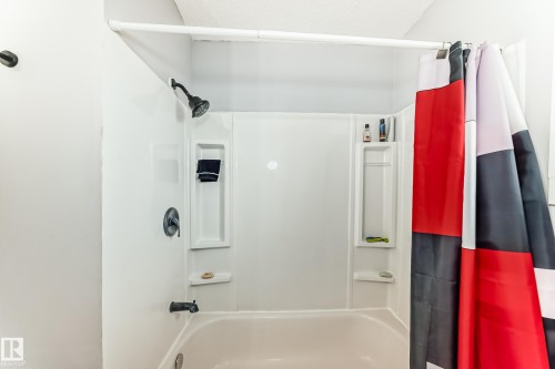 Bathtub and shower combination featuring a white surround - 3802 52 Street, Wetaskiwin, AB 