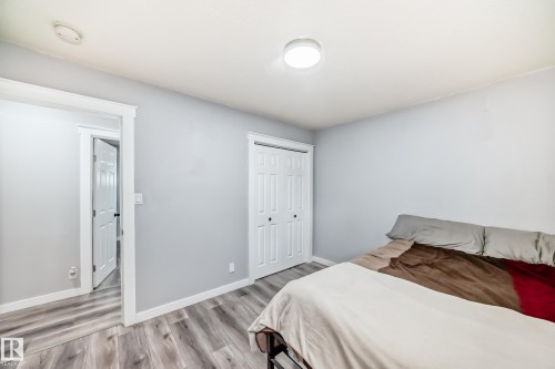 Light gray walls with white trim and wood-finish flooring - 3802 52 Street, Wetaskiwin, AB 