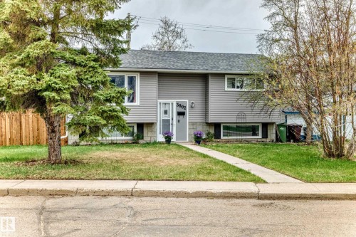 Split-level residence featuring gray horizontal siding and a dark gray shingle roof - 3802 52 Street, Wetaskiwin, AB 