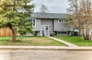 Split-level residence featuring gray horizontal siding and a dark gray shingle roof - 3802 52 Street, Wetaskiwin, AB 