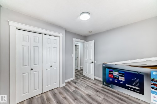 Interior room featuring wood-finish flooring, light gray wall paint, and white trim - 3802 52 Street, Wetaskiwin, AB 