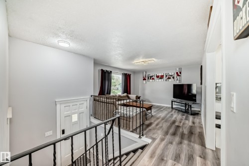 Open concept living space with grey wood-finish flooring - 3802 52 Street, Wetaskiwin, AB 