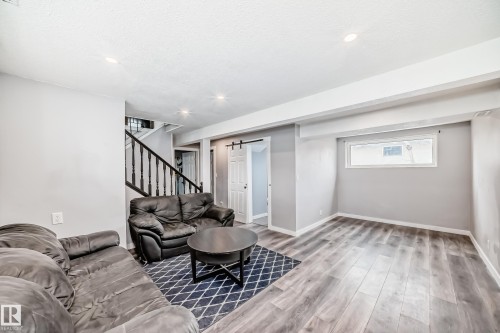 Spacious room with wood-finish flooring, recessed lighting, and light grey painted walls - 3802 52 Street, Wetaskiwin, AB 