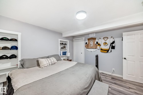Bedroom featuring neutral gray walls and wood-finish flooring - 3802 52 Street, Wetaskiwin, AB 