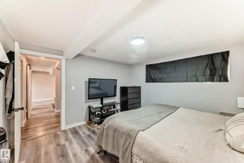 Spacious room featuring light wood-finish flooring and light gray walls - 3802 52 Street, Wetaskiwin, AB 