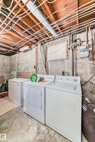 Basement utility area featuring concrete flooring, exposed ceiling joists, and a window with blinds - 3802 52 Street, Wetaskiwin, AB 
