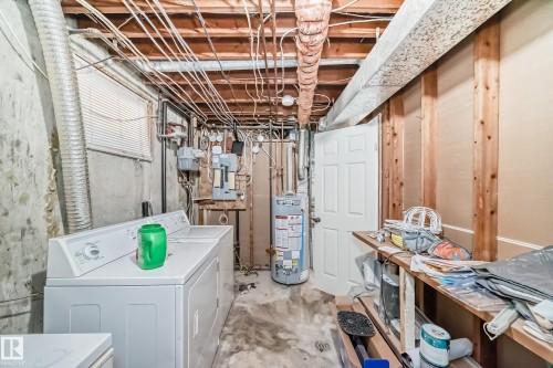 Basement utility area featuring exposed wood ceiling joists and concrete walls - 3802 52 Street, Wetaskiwin, AB 