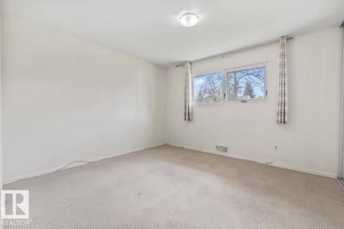 Room featuring light-toned carpeting, white walls, and a ceiling-mounted light fixture - 24 Elizabeth Drive, Fort Saskatchewan, AB - Indoor Photo Showing Other Room