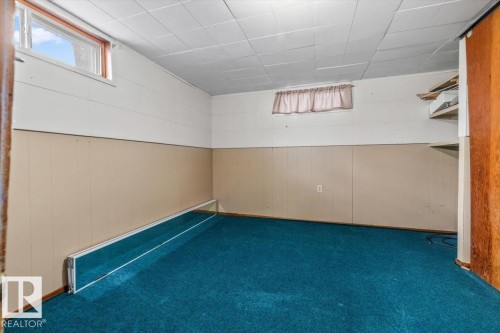 Room featuring blue carpet, white paneled walls, and beige wainscoting - 24 Elizabeth Drive, Fort Saskatchewan, AB - Indoor Photo Showing Other Room